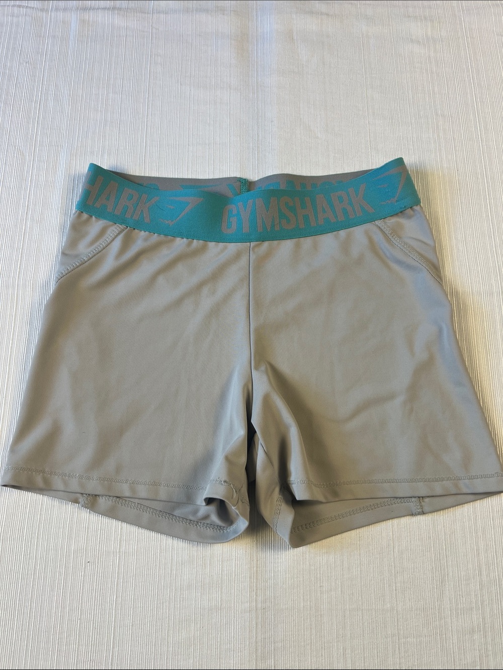 Gymshark Women's Light Gray Athletic Compression Shorts with Teal Logo Waistband
